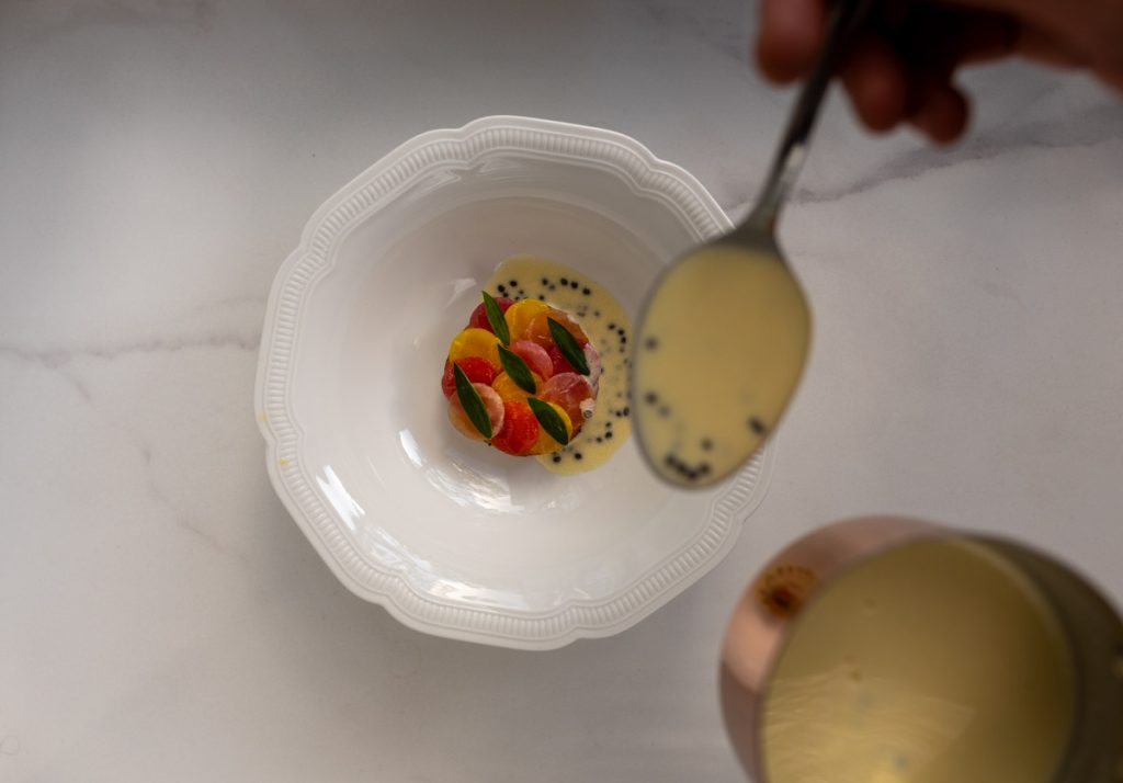 A plated dish at Ure — seafood, citrus and caviar, finished tableside